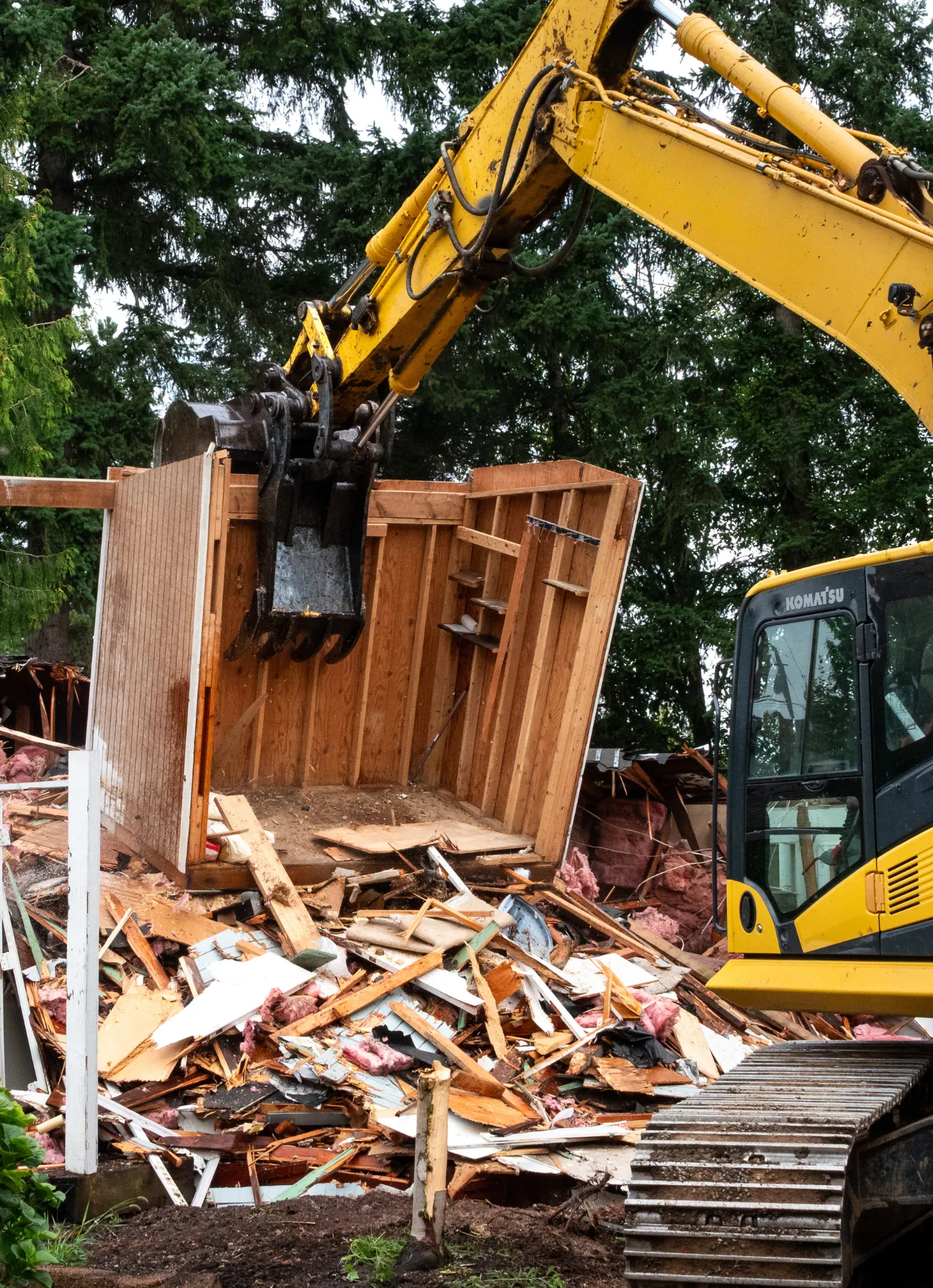 Heavy machinery breaking down a structure during a demolition project in Dallas, TX