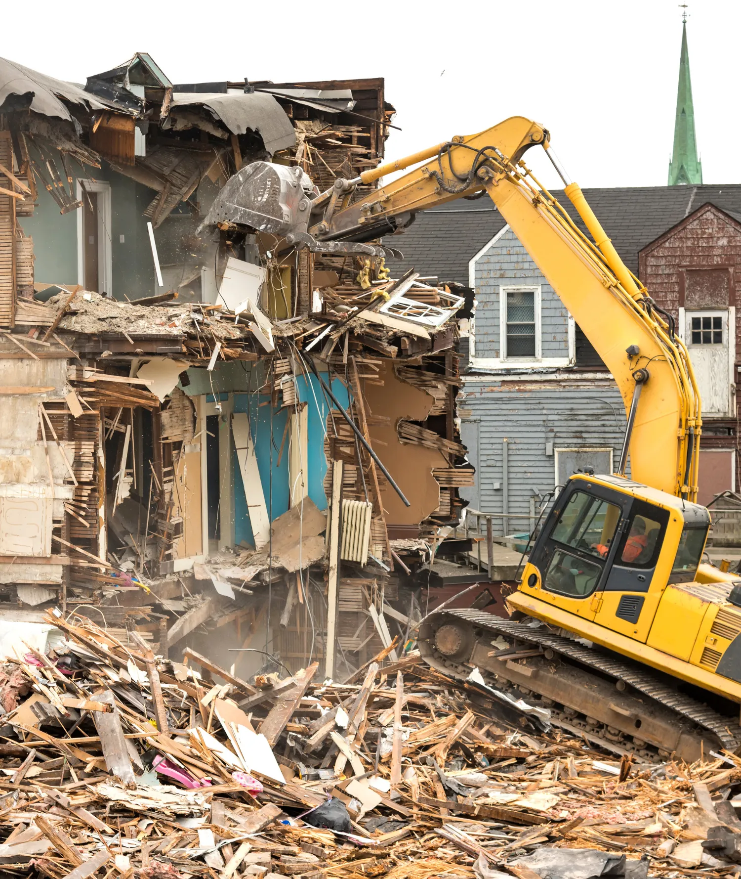 Heavy equipment excavator demolishing a residential house during a full demolition project in Dallas, TX