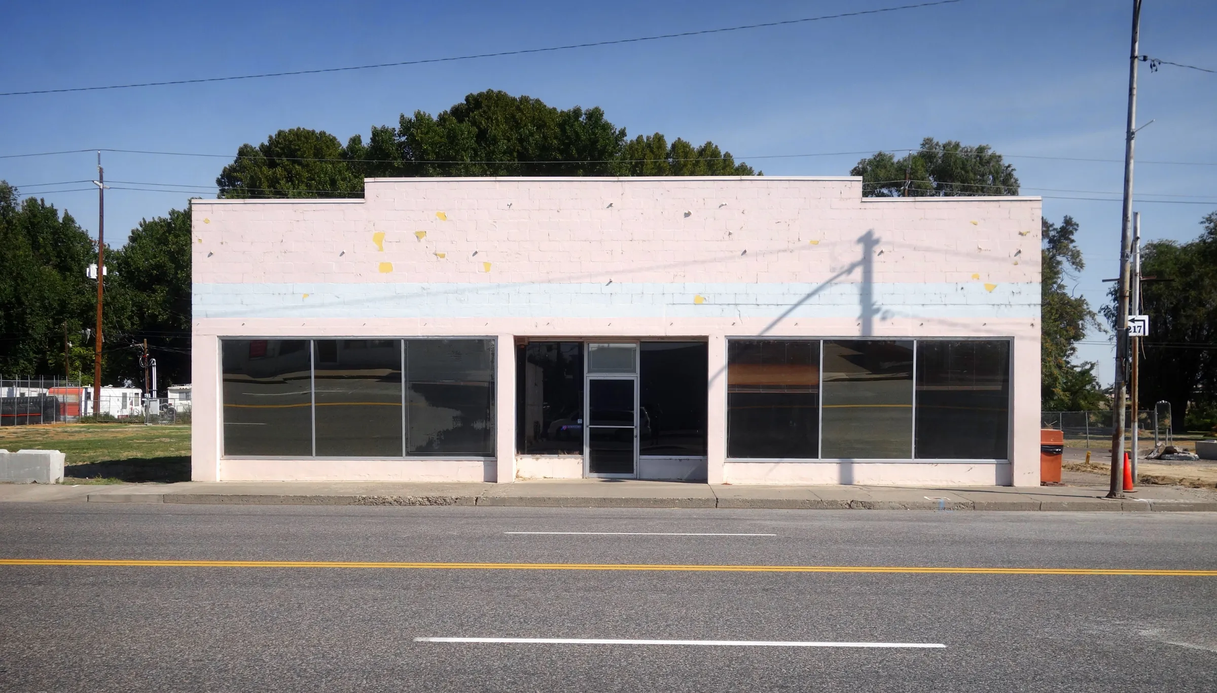 Old commercial storefront building in Dallas TX before demolition showing retail structure ready for teardown