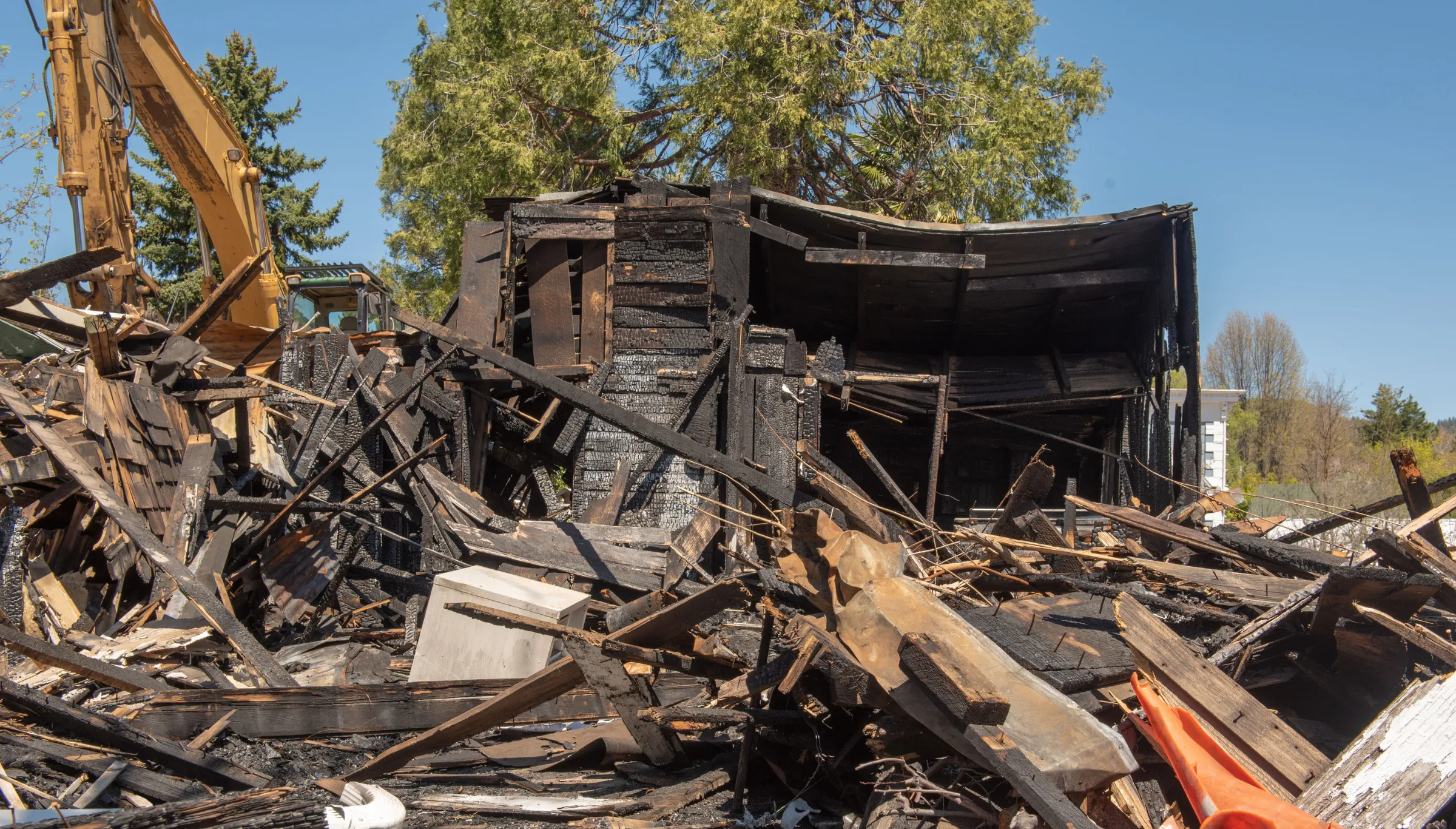 Emergency demolition in Dallas TX clearing fire-damaged building and hazardous debris after disaster response cleanup
