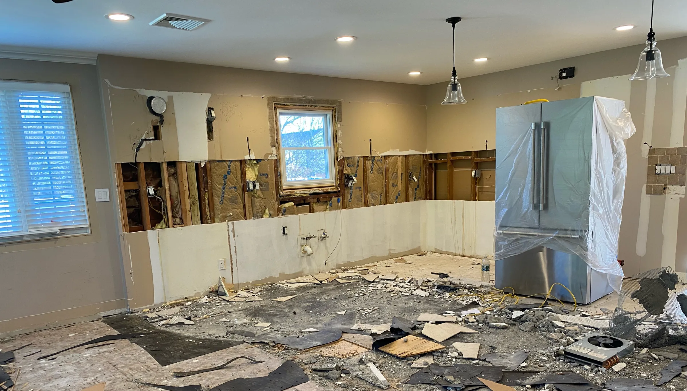 Kitchen demolition with exposed walls and debris during an interior demolition project in Dallas, TX